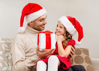 Image showing smiling father giving daughter gift box