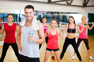 Image showing smiling trainer in front of group of people