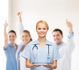 Image showing smiling female doctor or nurse with tablet pc