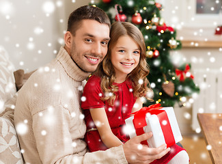 Image showing smiling father and daughter holding gift box