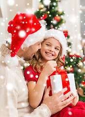 Image showing smiling father and daughter opening gift box