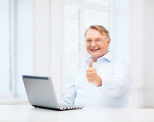 Image showing old man with laptop computer showing thumbs up