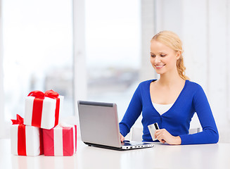 Image showing woman with gifts, laptop computer and credit card