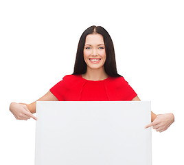 Image showing smiling young woman with blank white board
