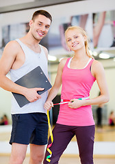 Image showing two smiling people with clipboard and measure tape