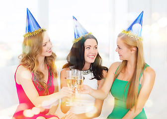 Image showing three women wearing hats with champagne glasses