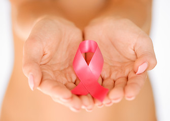 Image showing hands holding pink breast cancer awareness ribbon