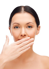 Image showing beautiful woman covering her mouth