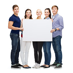 Image showing group of smiling students with white blank board