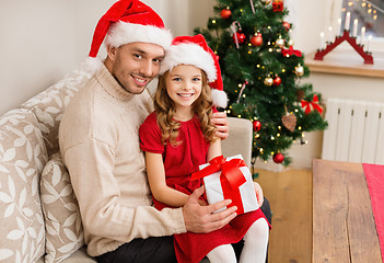 Image showing smiling father and daughter holding gift box