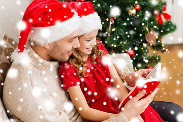 Image showing smiling father and daughter reading book