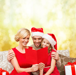 Image showing smiling family reading postcard