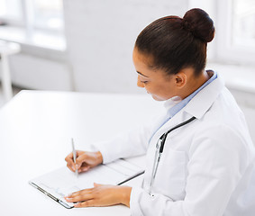 Image showing female doctor writing prescription