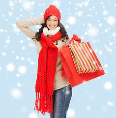 Image showing smiling woman in warm clothers with shopping bags