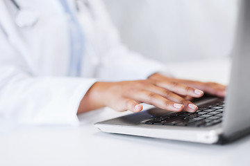 Image showing female doctor using her laptop computer