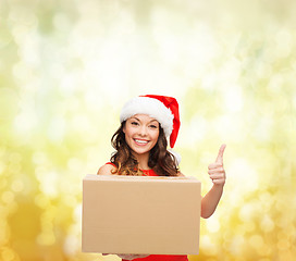 Image showing smiling woman in santa helper hat with parcel box