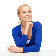Image showing happy smiling young woman dreaming and laughing