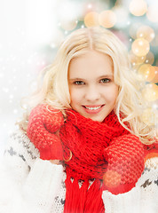 Image showing smiling teenage girl in red mittens and scarf