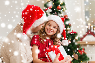 Image showing smiling father and daughter holding gift box