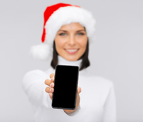 Image showing smiling woman in santa helper hat with smartphone