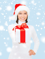 Image showing woman in santa helper hat holding gift box