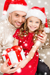 Image showing smiling father and daughter holding gift box