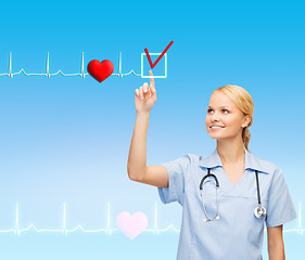 Image showing smiling doctor or nurse pointing to something