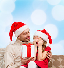 Image showing smiling daughter waiting for a present from father