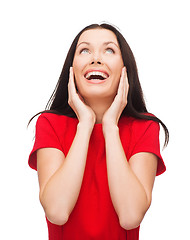 Image showing amazed laughing young woman in red dress