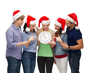 Image showing group of smiling students with clock showing 12