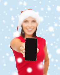 Image showing smiling woman in santa helper hat with smartphone