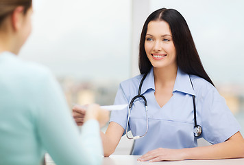 Image showing smiling doctor or nurse with patient