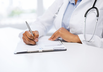 Image showing female doctor writing prescription