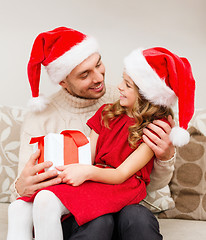 Image showing smiling father and daughter holding gift box
