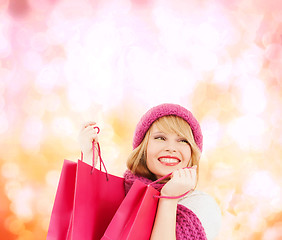 Image showing woman in pink hat and scarf with shopping bags