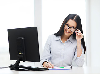 Image showing smiling businesswoman or student with eyeglasses