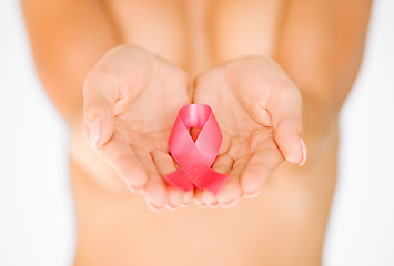 Image showing hands holding pink breast cancer awareness ribbon