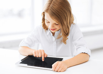 Image showing smiling little girl with tablet pc at school