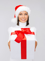 Image showing woman in santa helper hat holding gift box