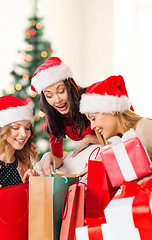 Image showing women in santa helper hats with shopping bags