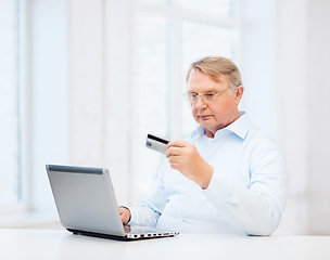 Image showing old man with laptop and credit card at home