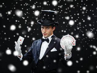 Image showing magician showing trick with playing cards