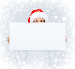 Image showing woman in santa helper hat with blank white board