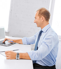 Image showing smiling businessman working in office