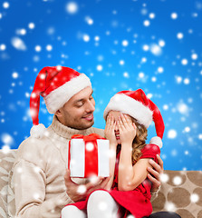 Image showing smiling daughter waiting for a present from father