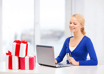 Image showing woman with gifts, laptop computer and credit card