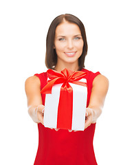 Image showing smiling woman in red dress holding gift box