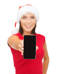 Image showing smiling woman in santa helper hat with smartphone