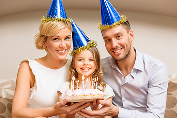 Image showing smiling family in blue hats with cake