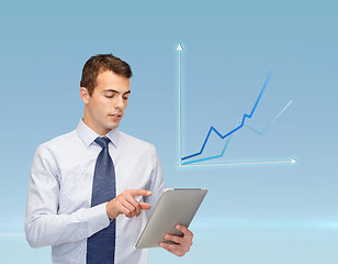 Image showing buisnessman with tablet pc and graph